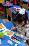 A child painting on a table

Description automatically generated